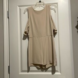 Cream romper with shoulder detail.